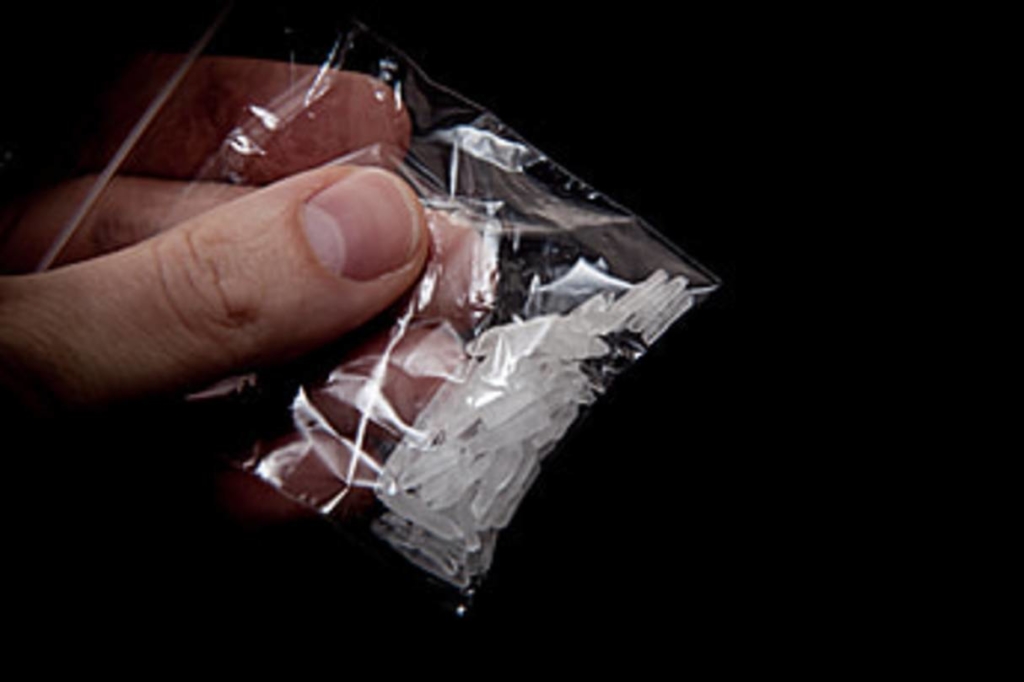 A close-up of crystal meth shards in small bag